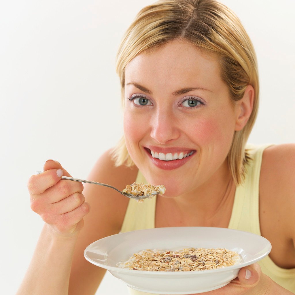 Smiling Woman Eating Cereal